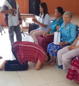 Pansak Kneeling in honor before his mother