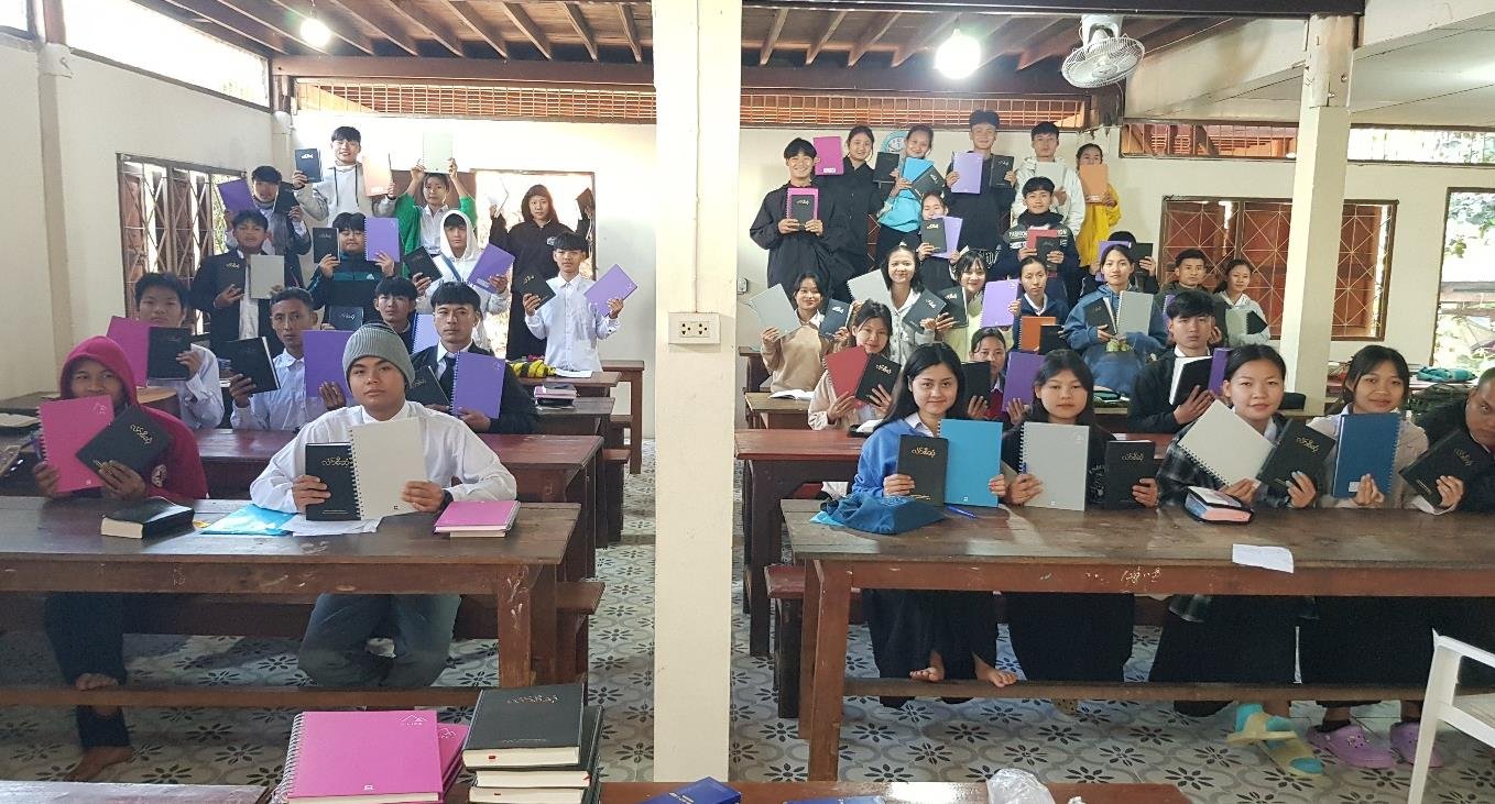 Nong Bua Bible School students on the first day of class holding their new Bibles. 
